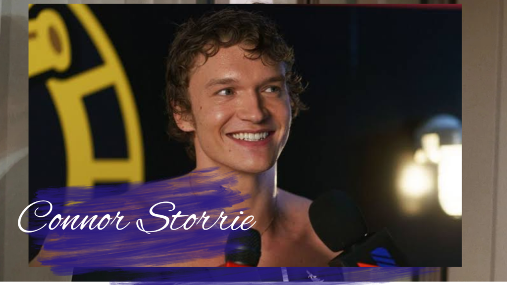 Connor Storrie net worth photo at red carpet event in a black suit